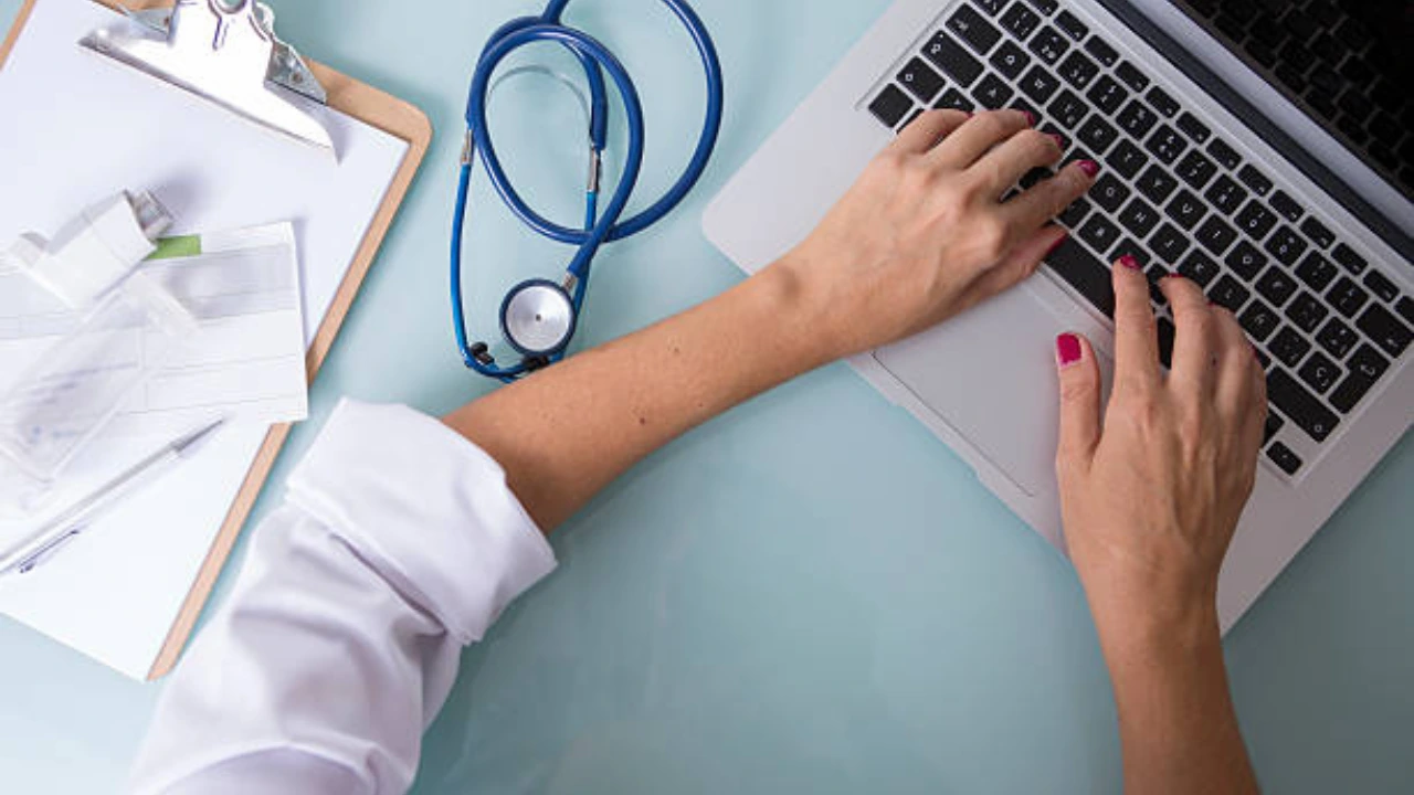 Clinician at a laptop with a stethoscope and clipboard, representing ICD-10 code F31.9 bipolar disorder billing